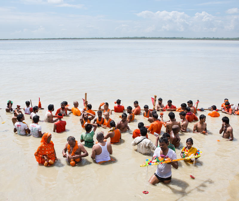 The connection between Water and Religion - Pilgrims taking holy bath in river Ganga and collecting the sacred water in pots at Sultanganj in district Bhagalpur, Bihar